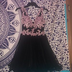 Size XS in woman’s black and pink with gems on the front from Windsor